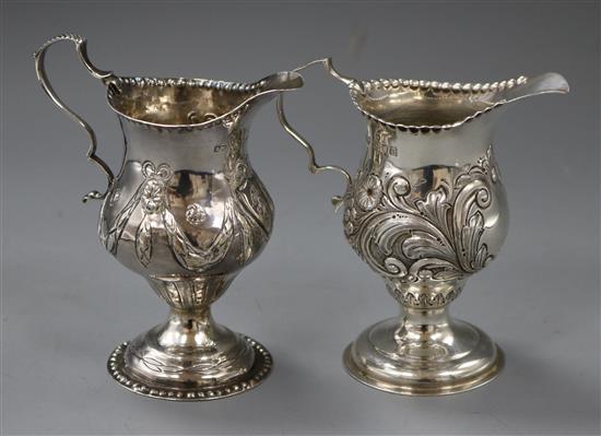 A George III silver cream jug, London, 1818, with later embossed decoration and a similar later silver cream jug. 5.5 oz.
